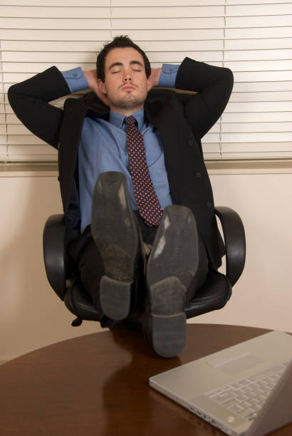 istock Businessman resting at desk with feet up 172902265