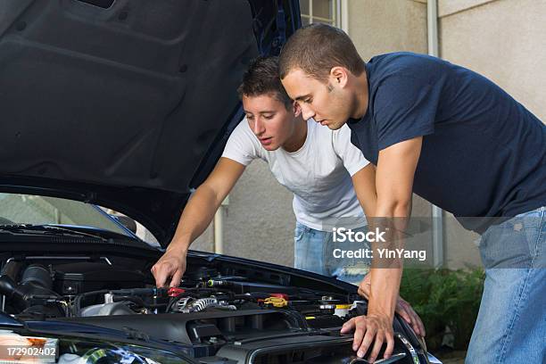 Car Repair And Engine Maintenance Men Working Examining Under Hood Stock Photo - Download Image Now