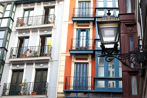 Beautiful and colorful facades with vintage streetlight on the old town of Bilbao, Spain