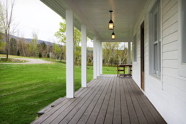 Rocking chairs grace a upper porch in a large lake front home in the Southern USA.