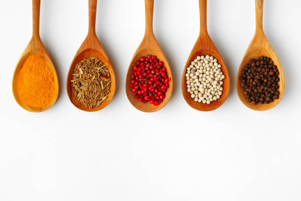 istock Wooden spoons with various spices isolated on white background 1729029446