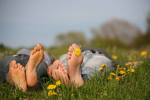 two people lie on the meadow and show dirty FAe