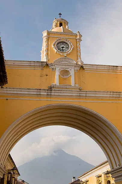 "The arc of Saint Cataline in Antigua, Guatemala is the most well known landmark in Antigua. The gate was built for the nuns to cross the street in privacy. Behind the gate is a view of the Volcano Agua."