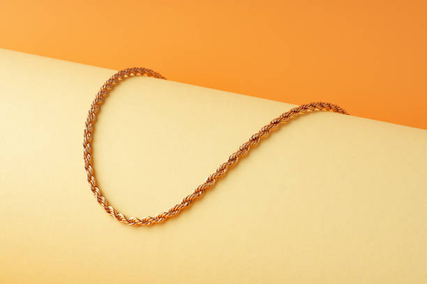 istock Golden chain on display on yellow background 1729046851