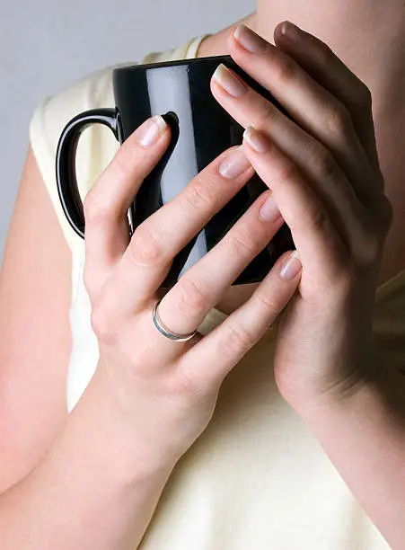 female hands holding a cup.