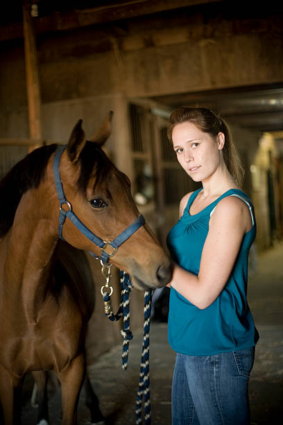 istock Young woman with horse in barn 172905753