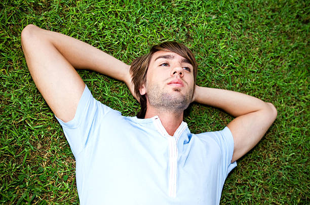 istock Young man relaxing on the grassy field 172907026