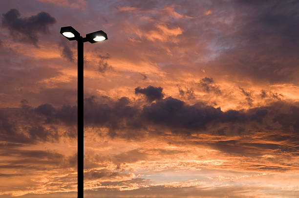 istock Modern Black Street Light Silhouetted, Fire, Fiery Sky, Dawn, Dusk 172907038