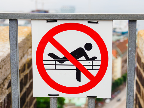 Forbidden climb over fence warning sign