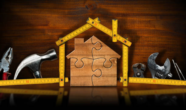 istock Home Improvement Concept - Wooden Model House and Work Tools 1729106511