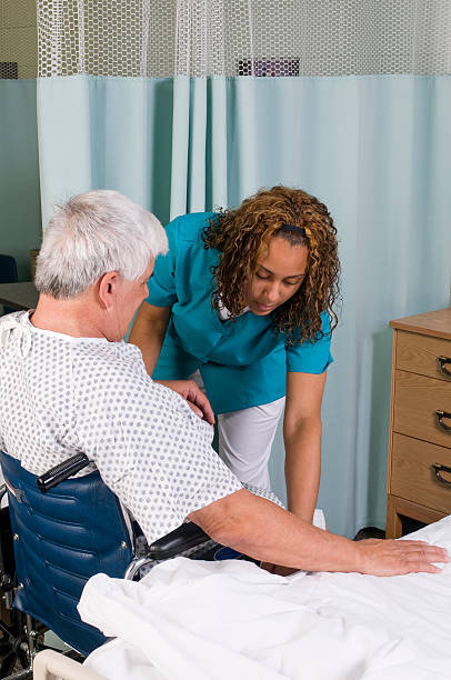 istock Assistance into wheelchair 172911484