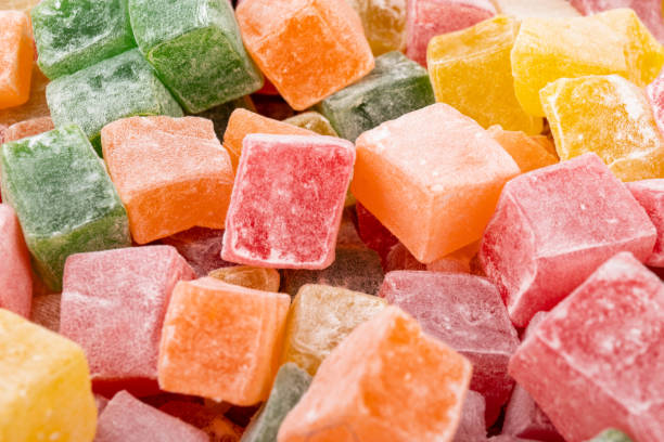 istock Closeup of multicolored cubes Turkish delight (Lokum). Selective Focus. Flat lay. 1729117361