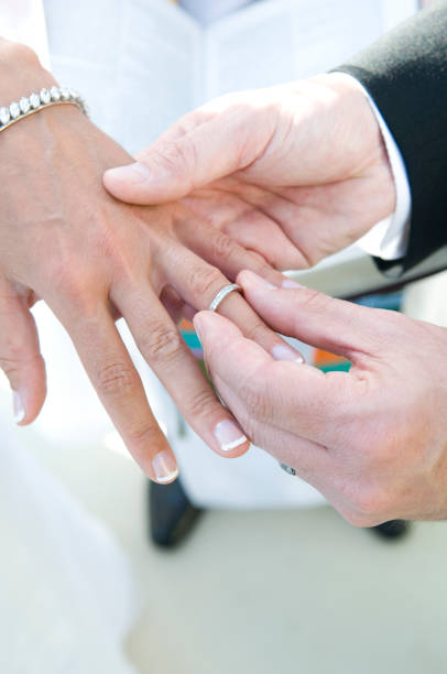 Bride Receiving Wedding Ring From Groom stock photo