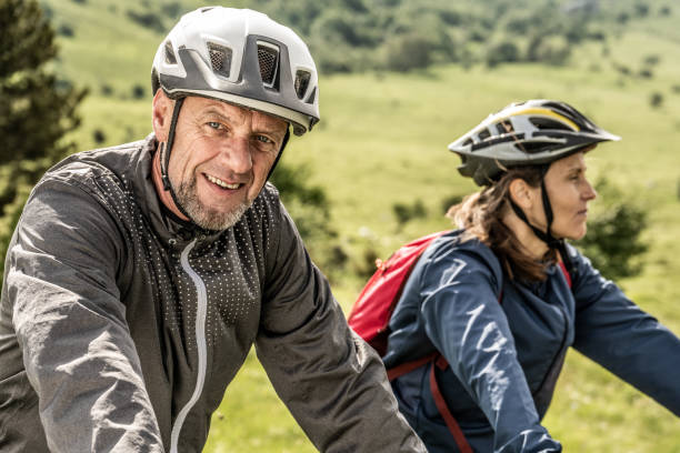 istock Couple in helmets riding bikes portrait 1729137924