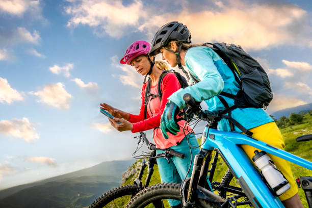 istock Female cyclists taking break while riding bike 1729137931