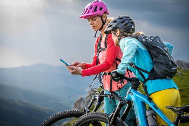 istock Female cyclists taking break while riding bike 1729137933