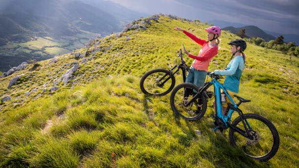istock Female cyclists taking break while riding bike 1729137935