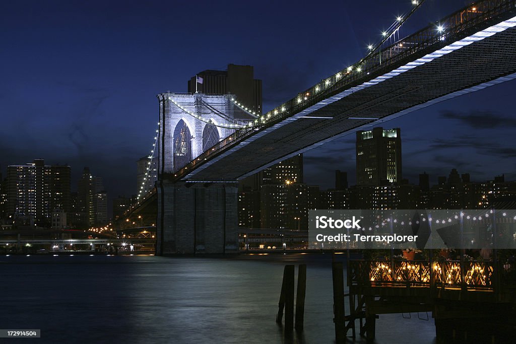 Brooklyn Bridge at Night "View across East River and Brooklyn Bridge at night, New York City, NY, USA." New York City Stock Photo