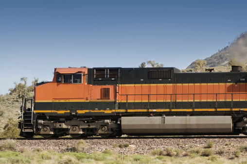 Freight train traveling through Arizona. Blurred terrain.