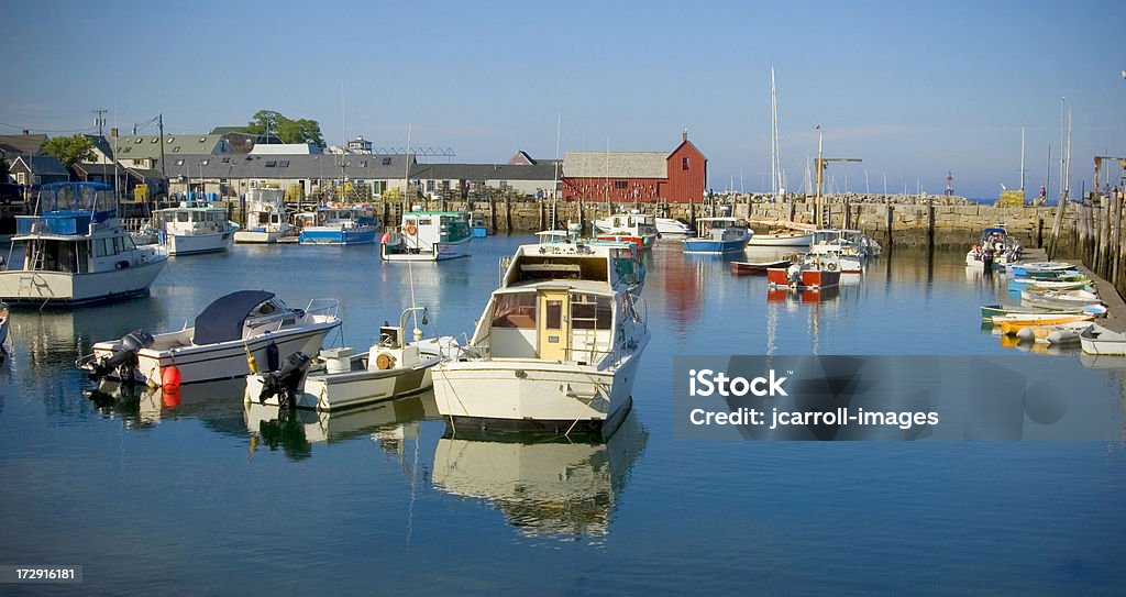 Motif #1 and Boats in Harbor. "Panarama of Rockport Harbor in Massachusetts with boats in foreground and Motif #1 in background.New England,Massachusetts, Rockport,port,harbor,marina,boat,fishing,peaceful,rock wall,retaining wall,breakwater,full frame,color image,photograph,dock,pier" Backgrounds Stock Photo
