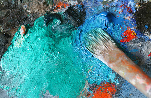 istock Paintbrush with oil paint on a classical palette - XL 172916285