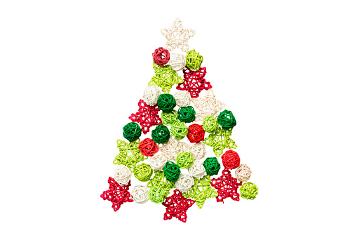 Isolated Christmas tree made from colored handmade ball decoration on colored background, view from above. New Year minimal concept .