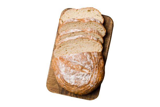 istock Freshly baked bread slices on cutting board isolated on white background . top view Sliced bread 1729164288