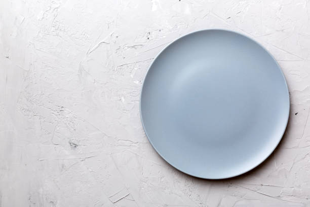 istock Top view of empty grey plate on cement background. Empty space for your design 1729164316