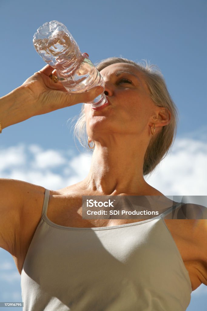 Senior Woman Drinking Bottle Of Water Outside See more from this Continuing Education / Healthy Living series: Drinking Stock Photo