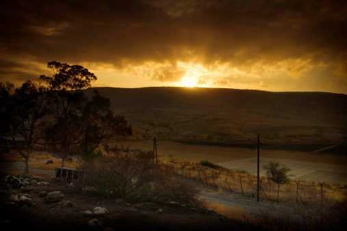 A scene from the middle East; the sun rising over the Golan Heights in Israel, looking toward Syria from a kibbutz. Horizontal with copy space.