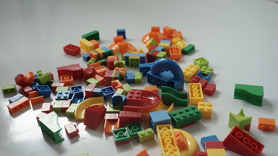 Plastic building blocks on a white background, close-up.