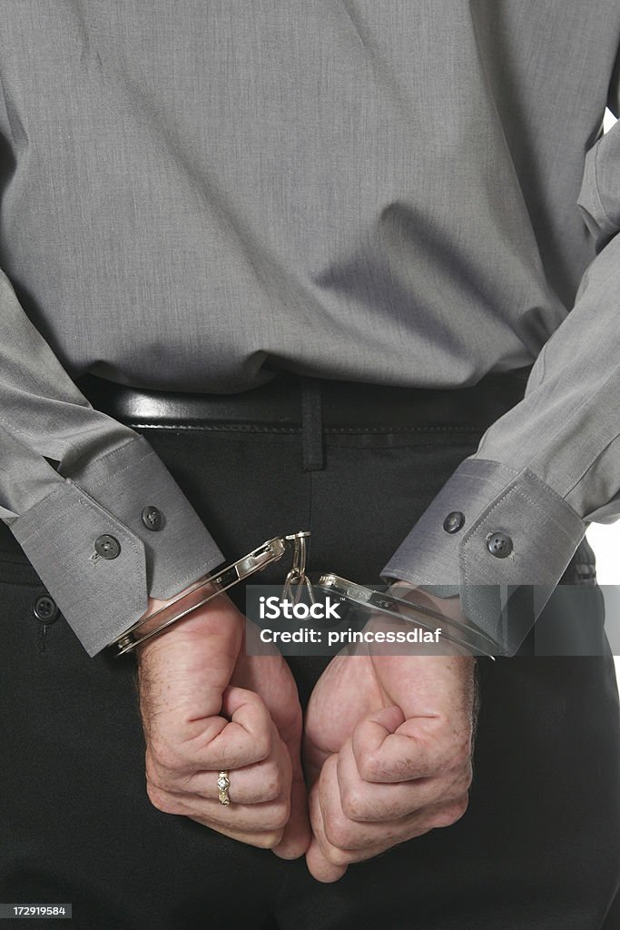 Busted Man with his hands cuffed behind his back Adult Stock Photo
