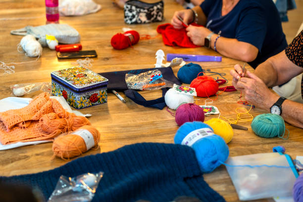 istock Crochet club. Ladies crocheting with colored wool. 1729199723