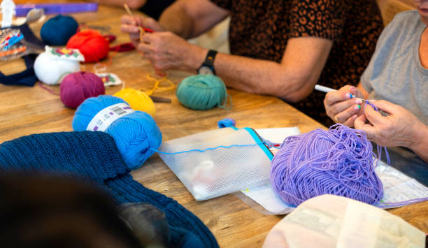 istock Crochet club. Ladies crocheting with colored wool. 1729199724