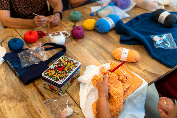 istock Crochet club. Ladies crocheting with colored wool. 1729199730