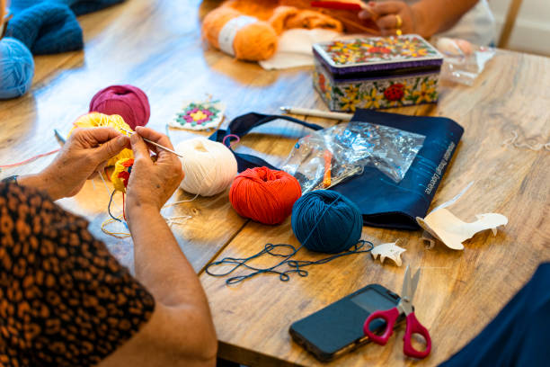 istock Crochet club. Ladies crocheting with colored wool. 1729200355