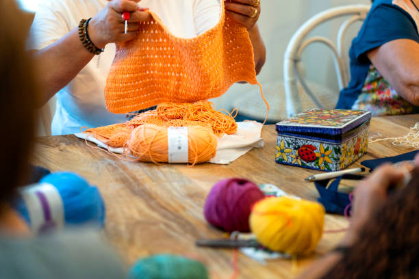 istock Crochet club. Ladies crocheting with colored wool. 1729200362