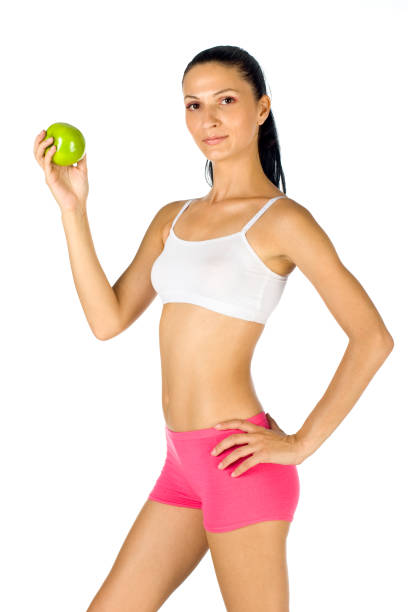 istock Young slim female with green apple 172920044