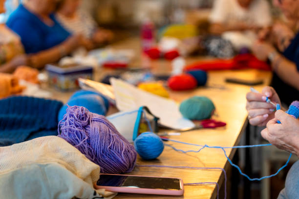 istock Crochet club. Ladies crocheting with colored wool. 1729200446