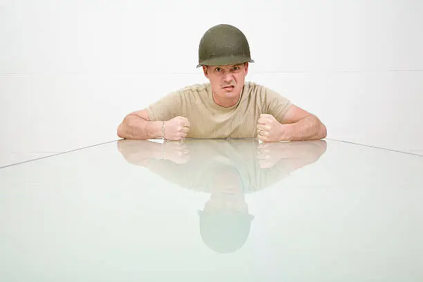 Picture of an angry man in a military helmet.