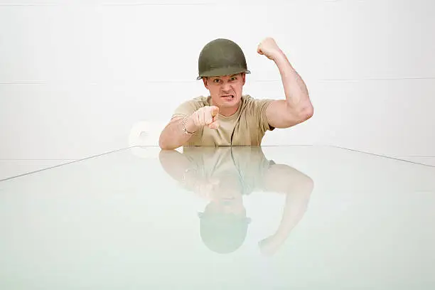 Picture of an angry man in a military helmet.