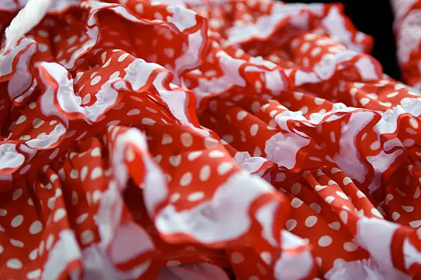 Closeup detail of a typically Spanish red and white pokadotted dress.
