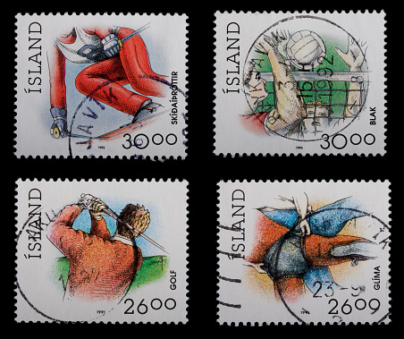 Four Icelandic Postage Stamps on a black background. All displaying different sport. Ski, handball, Icelandic wrestling and golf. They are from 1991 and 1992.