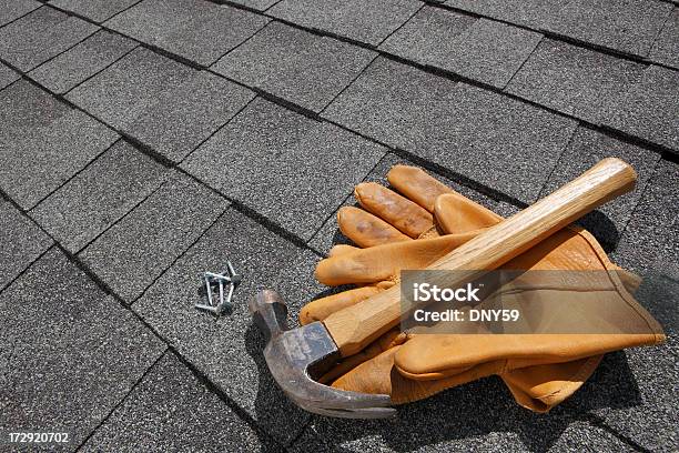 Hammer And Pair Of Gloves And Nails On Rooftop Stock Photo - Download Image Now - Rooftop, Roofer, Hammer