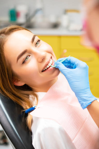 istock A dentist cleaning teeth with a plastic dental floss to the patient. 1729209790