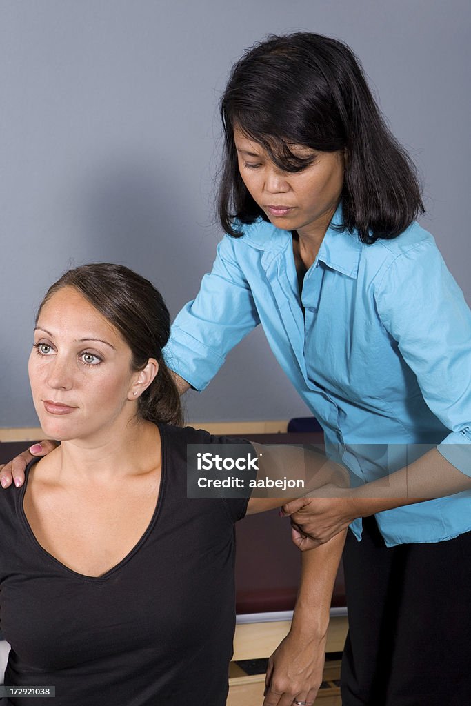 Physical Therapy womans visit to the physical therapist. Please view all images from this series along with other Activity Stock Photo