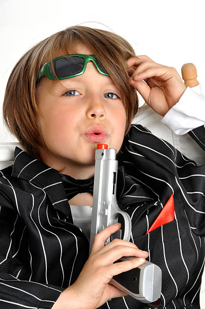 Young Bond or gangster blowing away gunsmoke