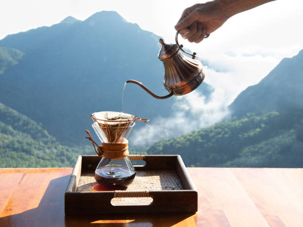 istock Male hand is dripping Arabica coffee on the balcony, 1729217601