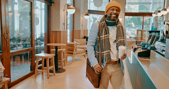 Happy man, customer and coffee shop counter for service, drink payment and hospitality in small business or startup. African person walking in cafe for menu, espresso choice and remote work in winter