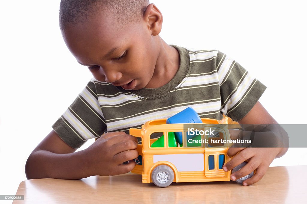 Young boy playing with school bus toy boy with toy school bus Child Stock Photo